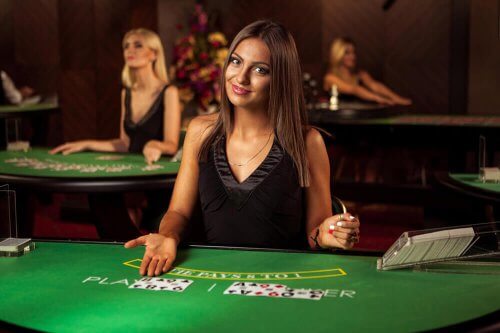 Live baccarat dealer at a Betbit table